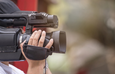 Close up short of video camera operator working with his equipmentの写真素材