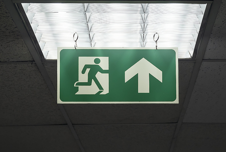 Green emergency exit sign  hang on the ceilingの写真素材