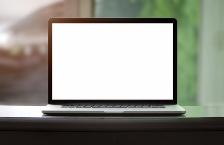 laptop with blank white screen on wooden tableの写真素材