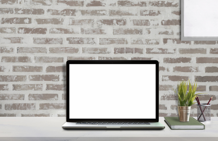 Mock up workspace with blank screen laptop and mockup poster at studio workplace.の写真素材