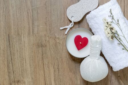 Top view Spa treatments set with herbal compressing ball, candles and towel on wooden background - Beauty and body care conceptの写真素材