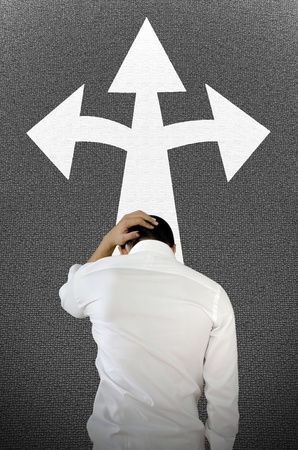 A photo of Young businessman is confusing. This photo describe the confuse of 3 choice.の写真素材