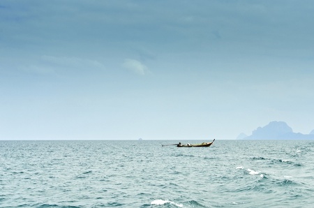 Country Fisherman fishing alone on long tail boatの写真素材