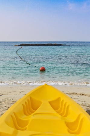 Paddle boats on sandy beach and blue seaの写真素材