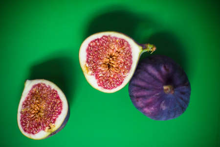 cut fig on green backgroundの写真素材