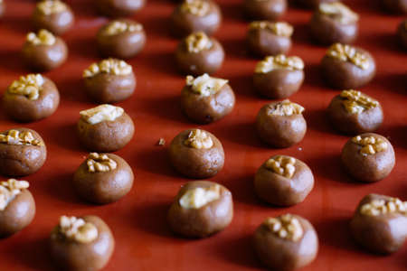 chocolate cookies with walnut on red backgroundの写真素材