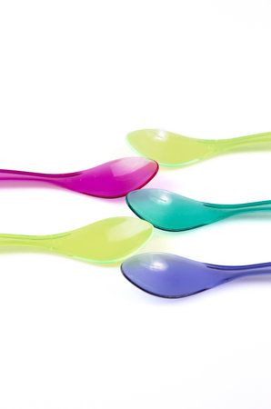 transparent color plastic spoons isolatedの写真素材