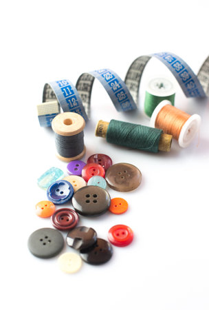 isolated spindles, buttons and centimeter on white