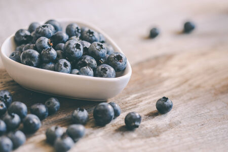 blueberries in a bowl on tableの写真素材
