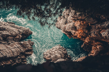 calm turquoise water with waves and rocks