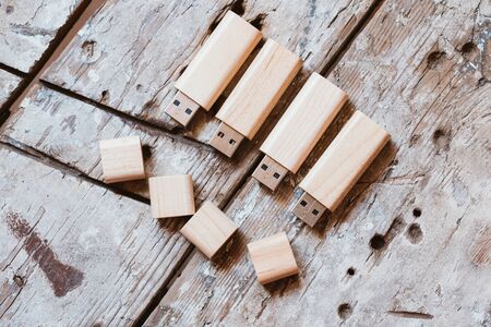Usb-sticks with open caps made of bamboo on wooden backgroundの写真素材