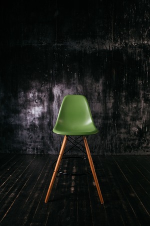 Modern green chair standing in empty interiorの写真素材