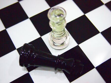 Two chess pieces on a black and white chess board の写真素材