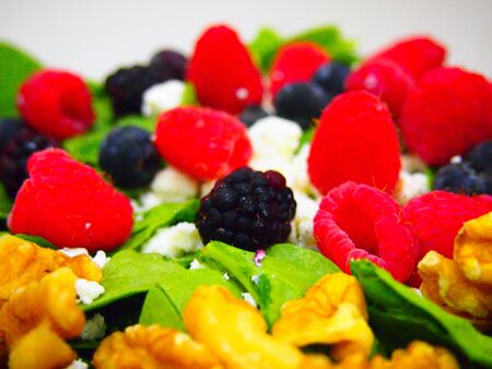 Beautiful bed of spring greens topped with goat cheese, walnuts, and fresh berries 
