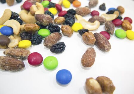 Trail mix of colorful candy and nuts の写真素材