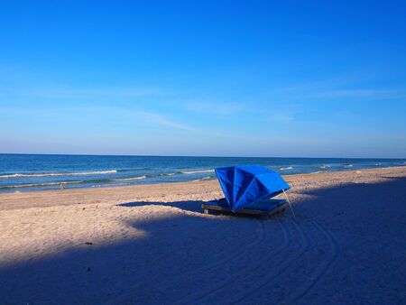 Beach cabana, sand, water, and blue sky at Indian Rocks Beach in Florida. Very early morning. Peaceful.の写真素材