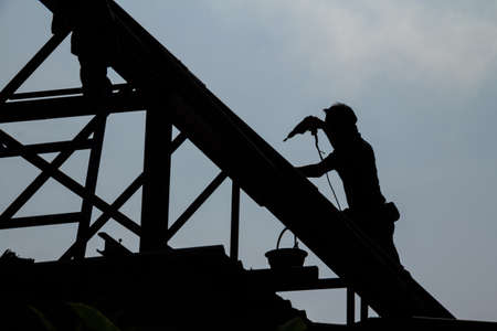 construction worker silhouette on the work place の写真素材