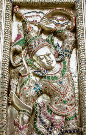 Native Thai style carvin on church door in the temple の写真素材