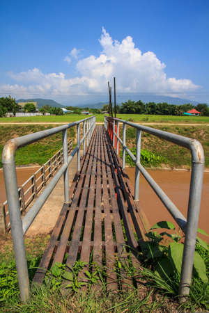 iron bridge over drainage ditchの写真素材