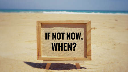 Motivational and inspirational quote - âIf not now, when?â on framed white paper. With blurred vintage styled background.の写真素材