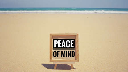 Motivational and inspirational quote - âPeace of mindâ written on a framed paper. With vintage styled background.の写真素材