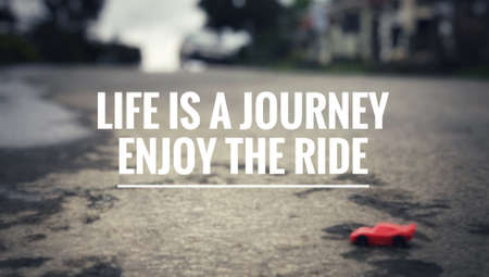 Motivational and inspirational quote - Life is a journey, enjoy the ride.  Blurred vintage styled background.の写真素材