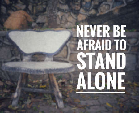 Motivational and inspirational quote - Never be afraid to stand alone. Blurred styled background.