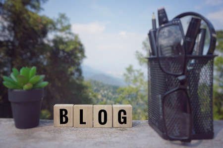 Conceptual - âBLOGâ written on wooden blocks. Blurred styled background.の写真素材