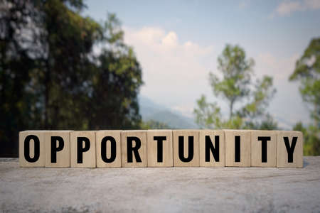 Motivational and inspirational word - âOPPORTUNITYâ written on wooden blocks with blurred styled background.の写真素材