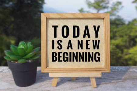 Motivational and inspirational quote - âToday is a new beginningâ written on a white board.With vintage styled background.の写真素材