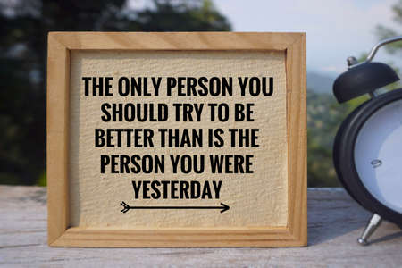 Motivational and inspirational quote - The only person you should try to be better than is the person you were yesterdayâ written on a white board. Vintage styled blurry background.の写真素材