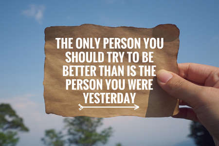 Motivational and inspirational quote - âThe only person you should try to be better than is the person you were yesterdayâ written on a paper. Vintage styled background.の写真素材