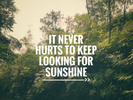Motivational and inspirational quote - âIt never hurts to keep looking for sunshineâ. Blurred vintage styled background.の写真素材