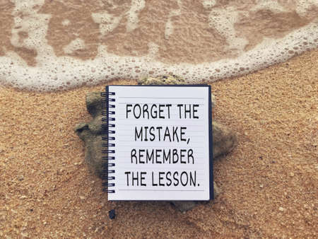 Motivational and inspirational wording - Forget The Mistake, Remember The Lesson written on a notebook.の写真素材