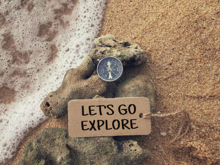 Motivational and inspirational wording - Letâ€™s Go Explore written on a tagged paper.