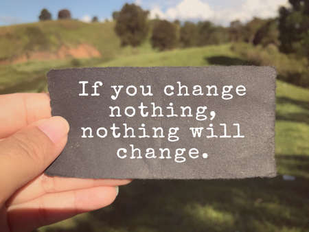Motivational and inspirational wording - If You Change Nothing, Nothing Will Change written on a paper. Blurred styled background.の写真素材