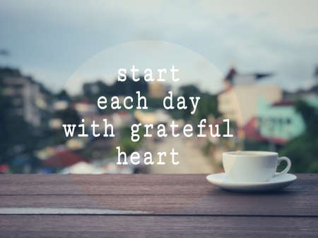 Motivational and inspirational wording - Start Each Day With Grateful Heart. Blurred vintage styled background.の写真素材