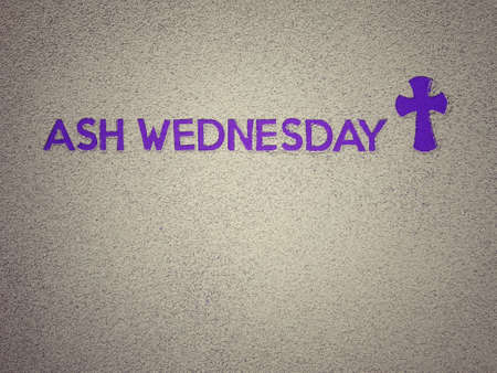 Ash Wednesday, Lent Season and Holy Week concept. Ash Wednesday wording and Christian Holy cross shape on background of scattered ashes.の写真素材