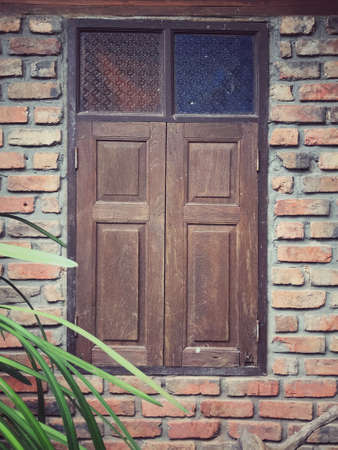 A weathered and closed wooden windows of a building.の写真素材