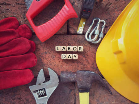 Labor Day concept. LABOR DAY written on wooden blocks. With background of working tools.の写真素材
