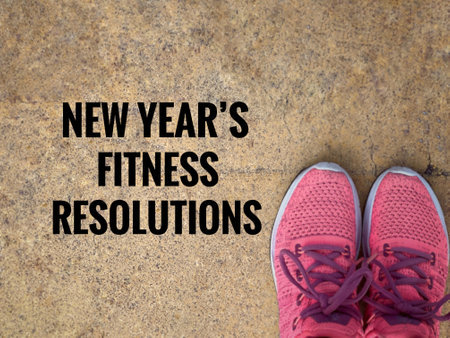 Motivational and inspirational wording. New Yearâs Fitness Resolutions written on vintage blurred light yellow asphalt background.の写真素材