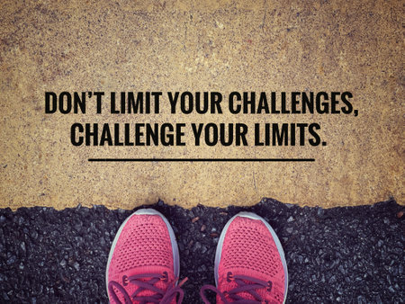 Motivational and inspirational wording. âDonât Limit Your Challenges, Challenge Your Limitsâ written on blurred vintage background.の写真素材