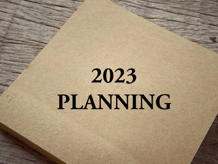 New Year plan concept. 2023 Planning written on a paper. With blurred vintage styled background.の写真素材
