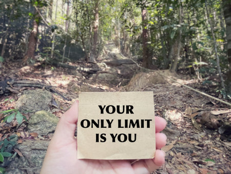 Motivational and inspirational wording. Your only limit is you. Written on a notepad. With blurred styled background.の写真素材