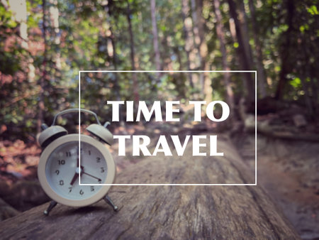 Motivational and inspirational wording. Time to travel. Written on blurred vintage styled background.の写真素材