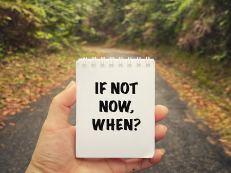 Motivational and inspirational wording. If Not Now, When? written on a notepad. With blurred vintage styled background.の写真素材