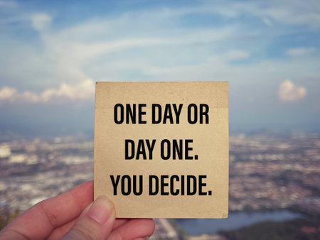 Motivational and inspirational wording. One Day Or Day One. You Decide. With blurred styled background.の写真素材