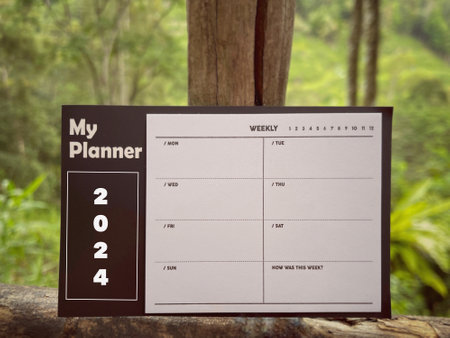 New Year motivational concept. My Planner 2024 written on notepad. With blurred styled background.