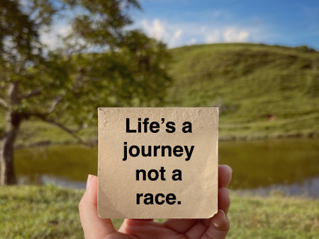 Motivational and inspirational wording. Lifeâ€™s a journey not a race written on a notepad....