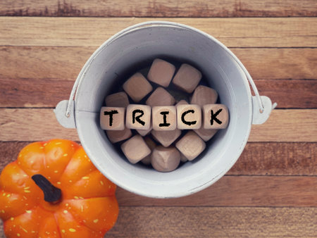 October celebration and Halloween concept. TRICK written on wooden blocks. With blurred styled background.の写真素材